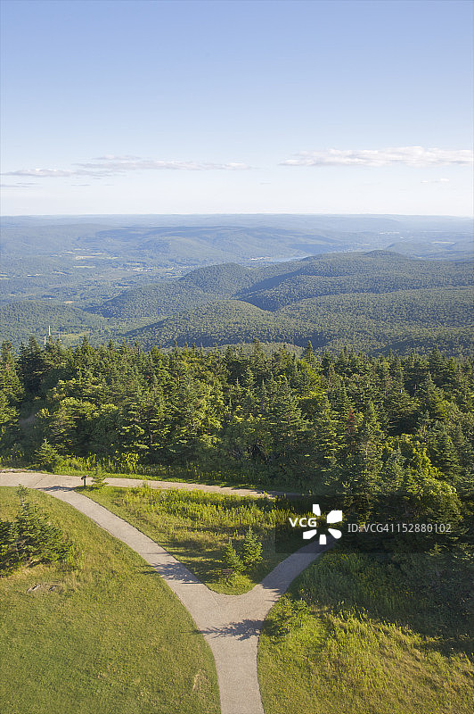 树木山峦天空下的分岔小路图片素材
