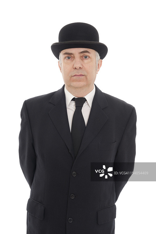 中年男人身穿黑色西装，领带和高顶礼帽图片素材