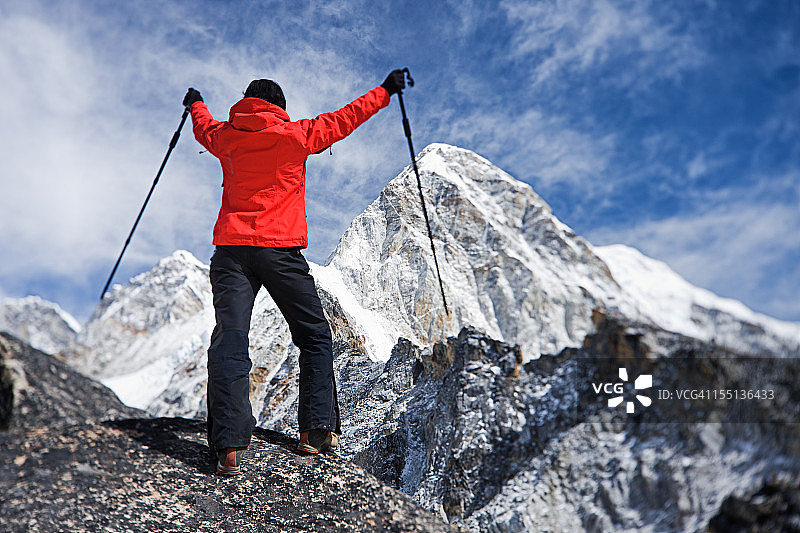 女徒步旅行者在卡拉帕塔山，背景是珠穆里峰，喜马拉雅山脉图片素材