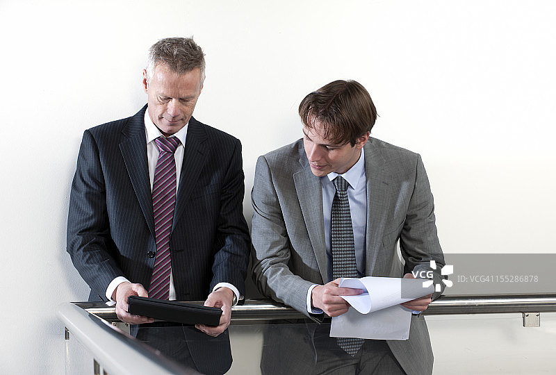 两位商人在走廊里看Ipad图片素材