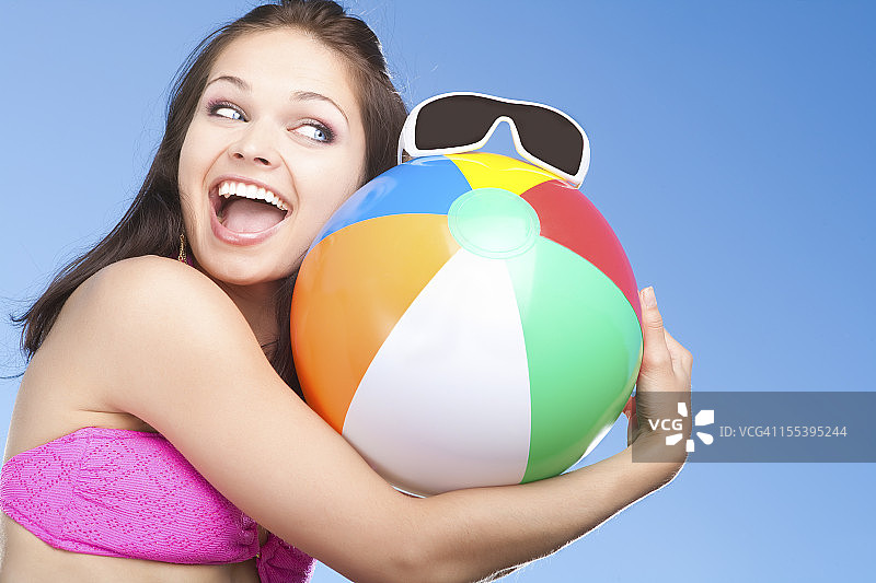 面带微笑的女人拿着沙滩球图片素材