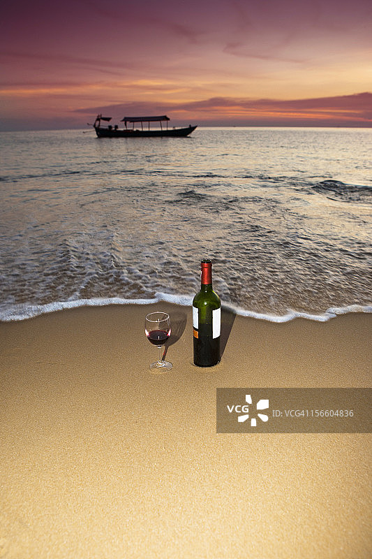 沙滩上的酒瓶和酒杯图片素材