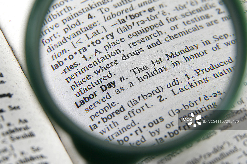 放大镜下的劳动节释义图片素材