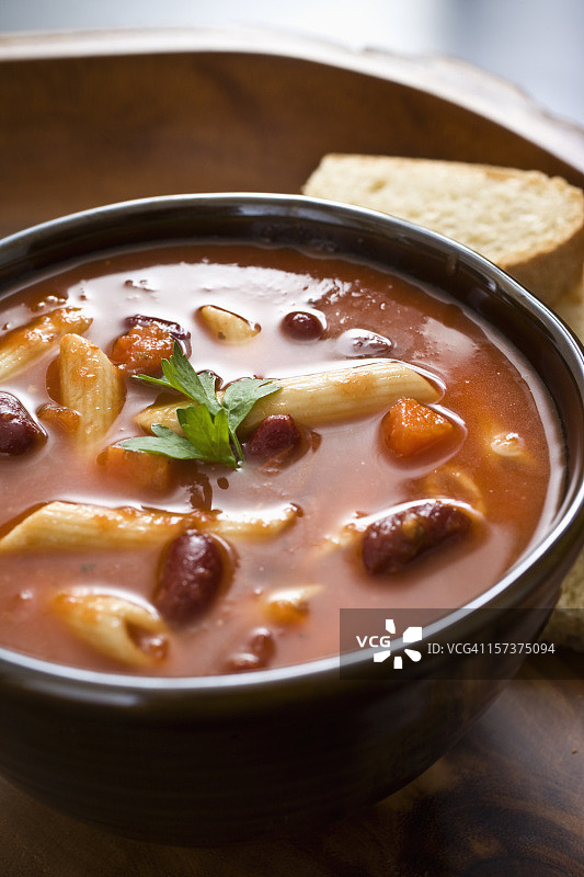 木板上的红汤意面与面包图片素材