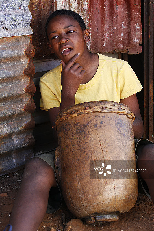 沉思的非洲男孩和鼓图片素材