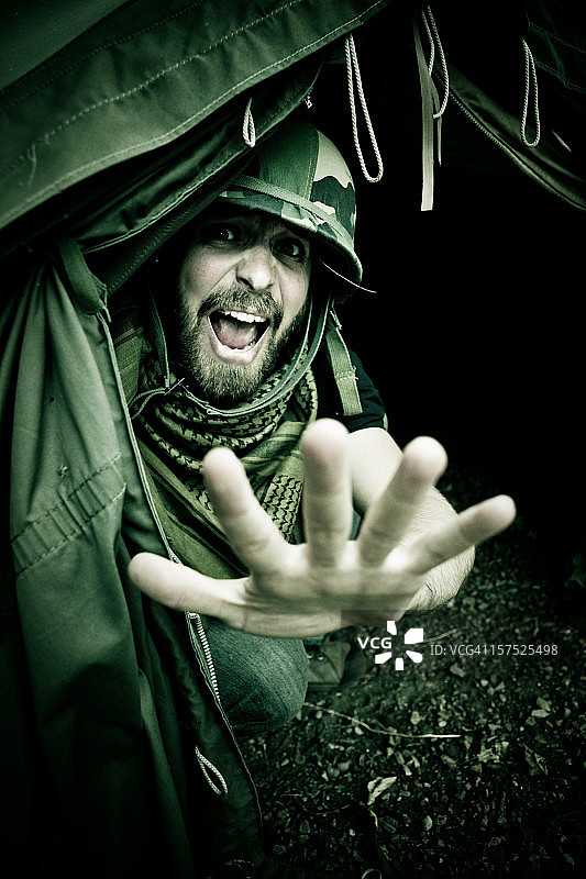 害怕的士兵从帐篷里向外看图片素材