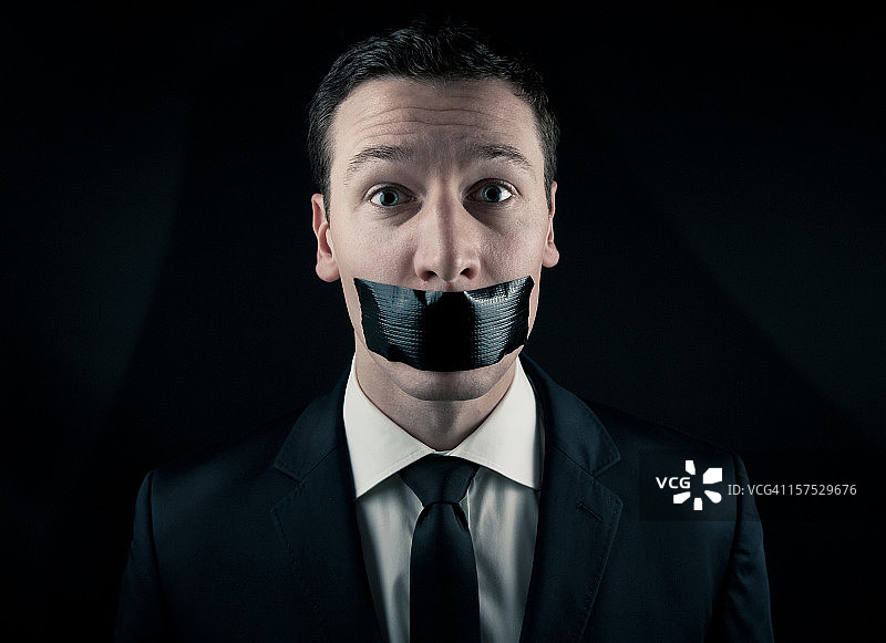 被堵住嘴的商人图片素材