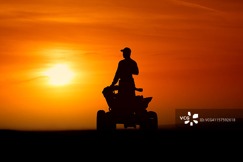 日落下的四轮摩托车图片素材