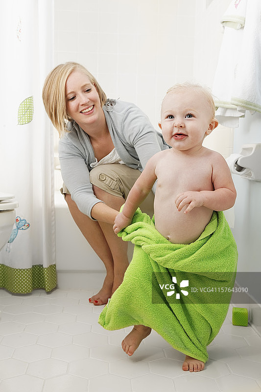 年轻母亲和幼儿在浴缸里玩耍图片素材