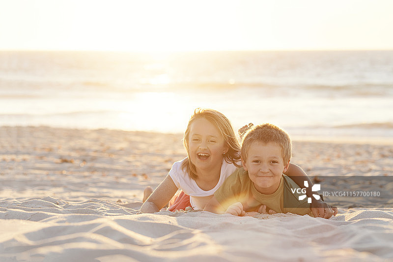 孩子们在日落时分的沙滩上玩耍图片素材