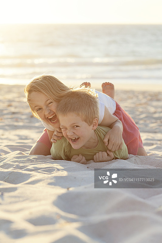 男孩和女孩在海滩上玩耍图片素材