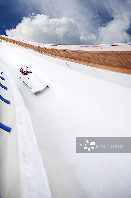 雪橇高速滑下赛道，背后是云图片素材