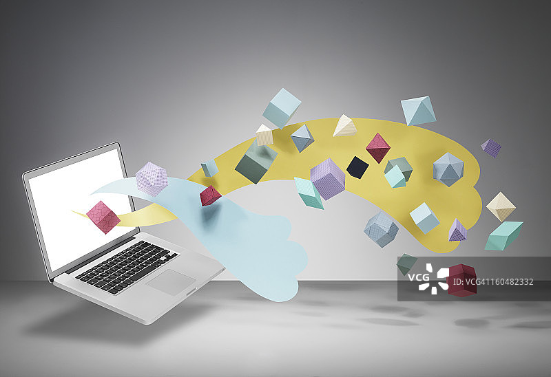 屏幕上漂浮着几何形状的笔记本电脑图片素材