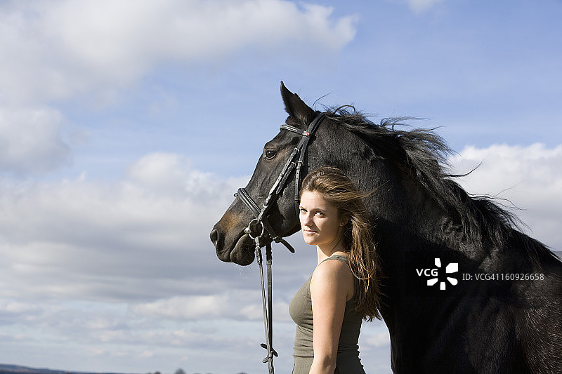 少女和黑色马的人像图片素材
