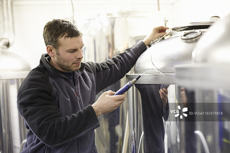 在小型啤酒厂检查温度的酿酒师图片素材