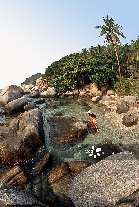 女人在泰国花岗岩巨石上攀岩图片素材