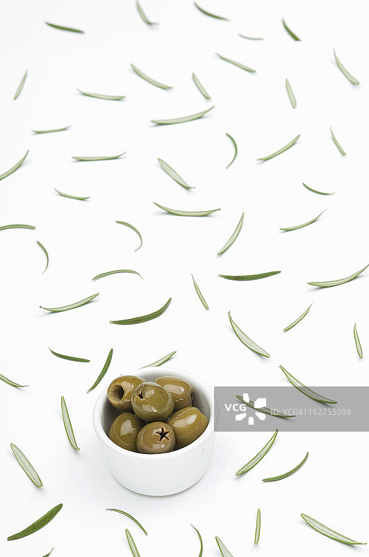 白色背景下的碗装绿色橄榄图片素材