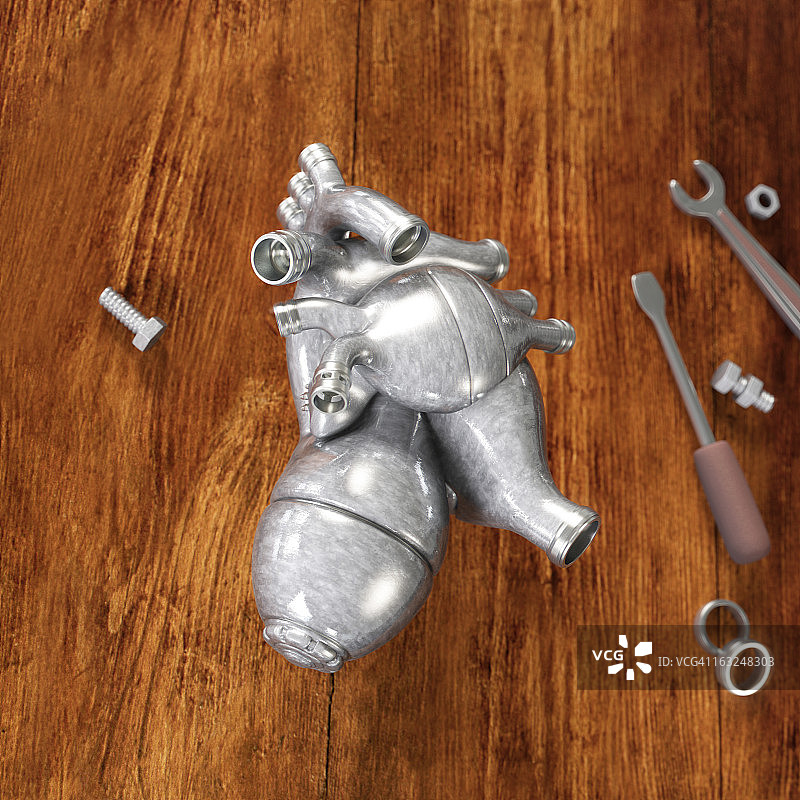 木桌上的金属人工心脏图片素材