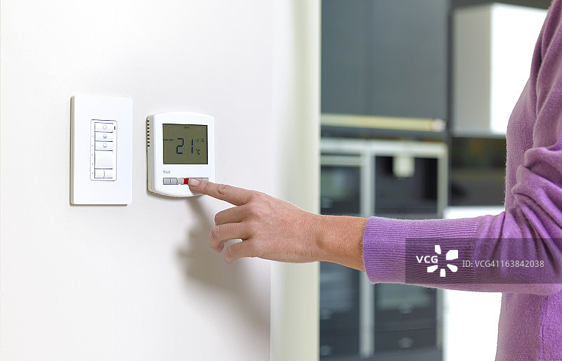 年轻女人更换暖气设备图片素材