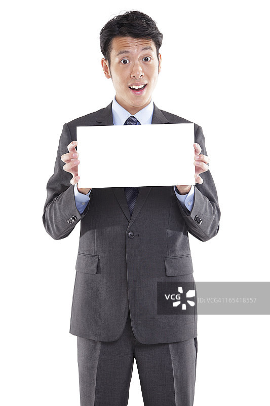 亚洲男商人举着空白标牌图片素材