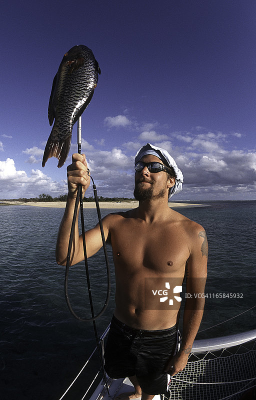 新喀里多尼亚 泰尼亚岛，男子和鱼图片素材