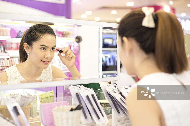 亚洲女性在化妆品商店购物图片素材