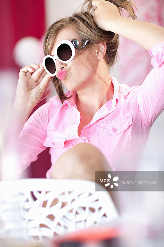 戴着太阳镜做鬼脸的少女图片素材