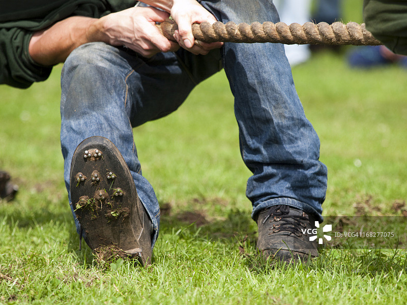 拔河比赛中男人拉绳子图片素材