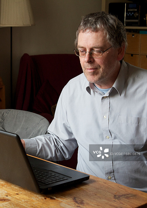 使用笔记本电脑的年长男人图片素材