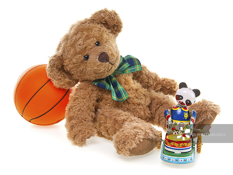 可爱的泰迪熊、发条铁皮玩具和球图片素材