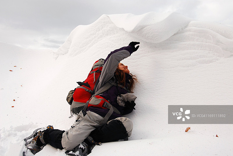 年轻女子触摸巨大的雪檐图片素材
