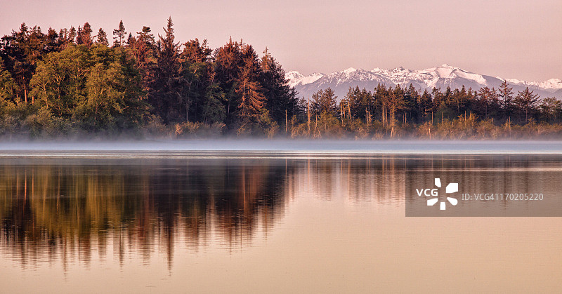 湖面倒影树木和山脉的黎明图片素材