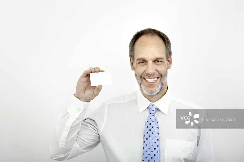 拿着空白卡片的中年商人图片素材
