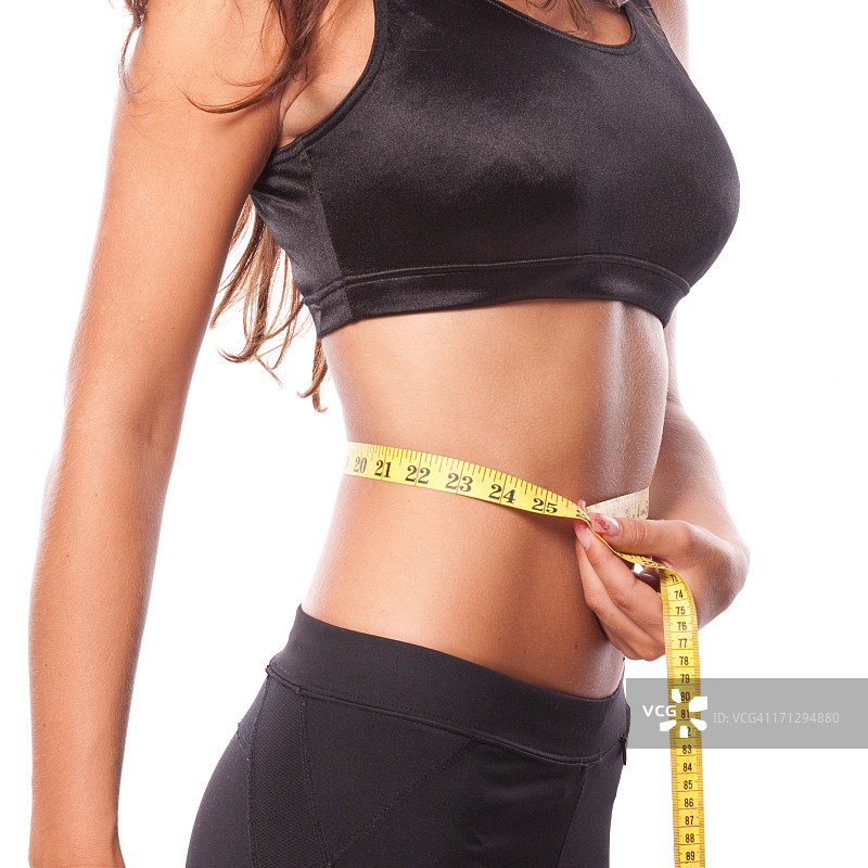 美丽的女人测量腰围图片素材