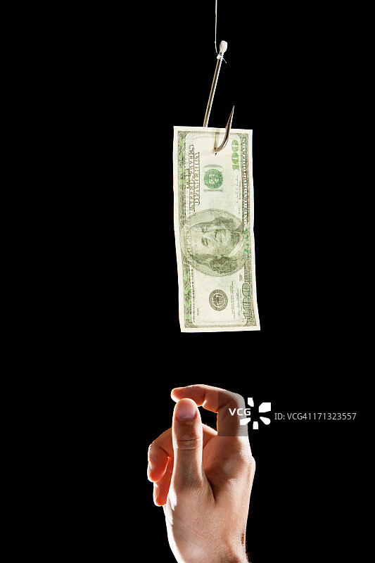 鱼钩和人手上的钱图片素材