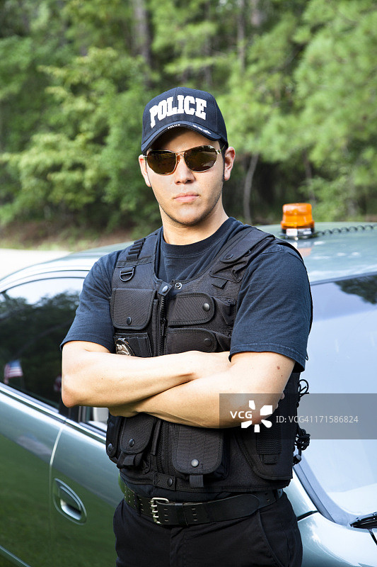 拉丁裔警察站在警车旁图片素材