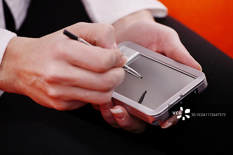 在掌上电脑上书写的手部特写图片素材