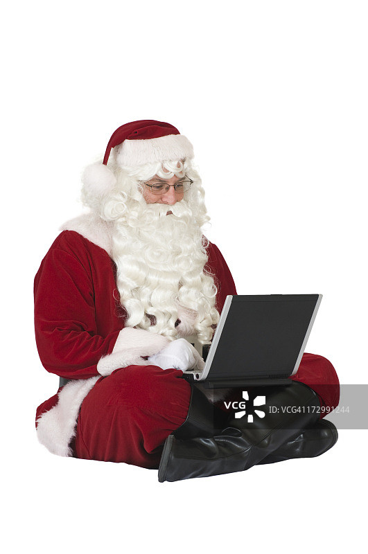 使用笔记本电脑的圣诞老人图片素材