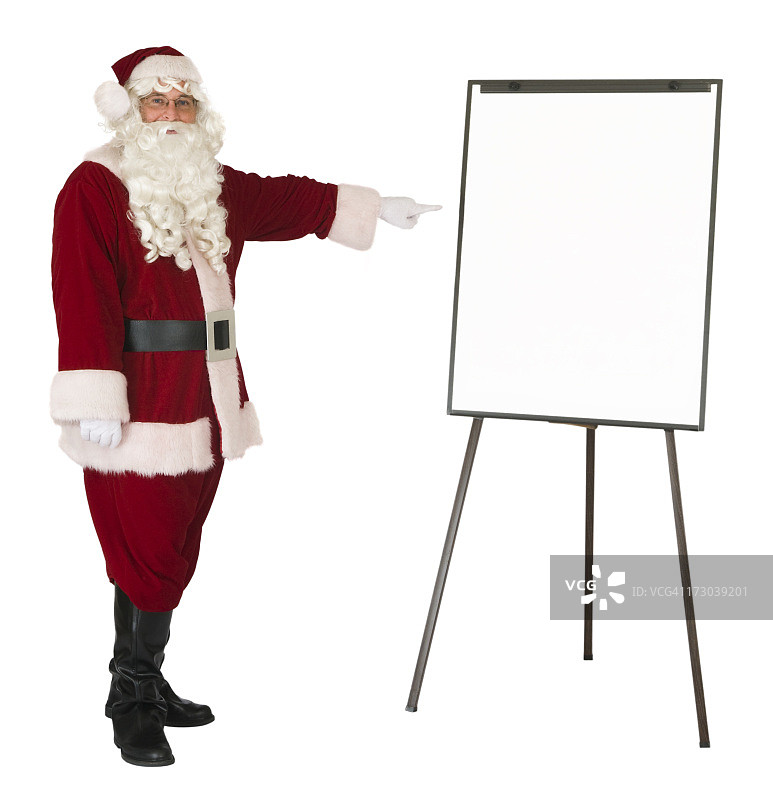 圣诞老人指向一个独立的白板图片素材