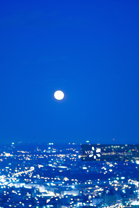 夜晚蓝色散焦城市景观与满月图片素材