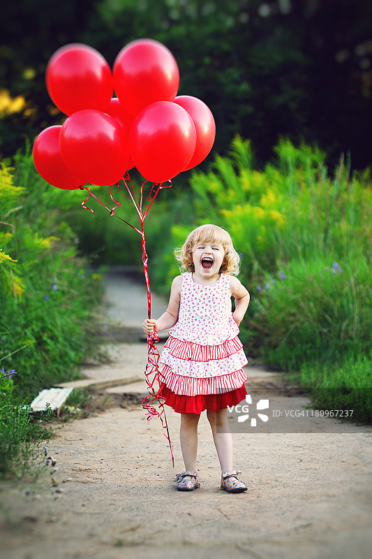 夏天里拿着气球欢笑的小女孩图片素材