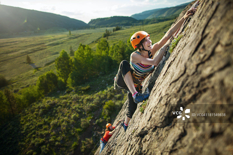男人和女孩在日落时攀岩图片素材