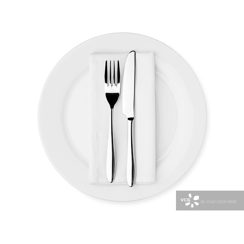 晚餐餐具摆设：白色盘子、刀、叉和餐巾图片素材