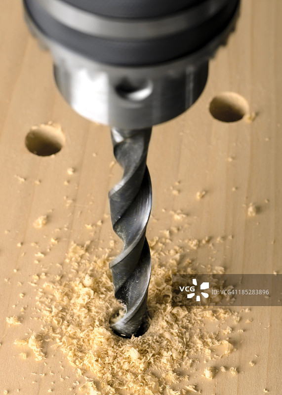 钻床和麻花钻头钻入木材图片素材