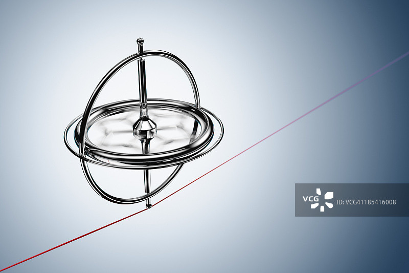 在红线上平衡的旋转陀螺仪图片素材