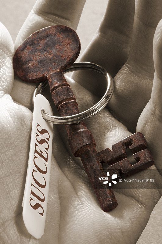 手持带有成功戒指的骷髅钥匙图片素材