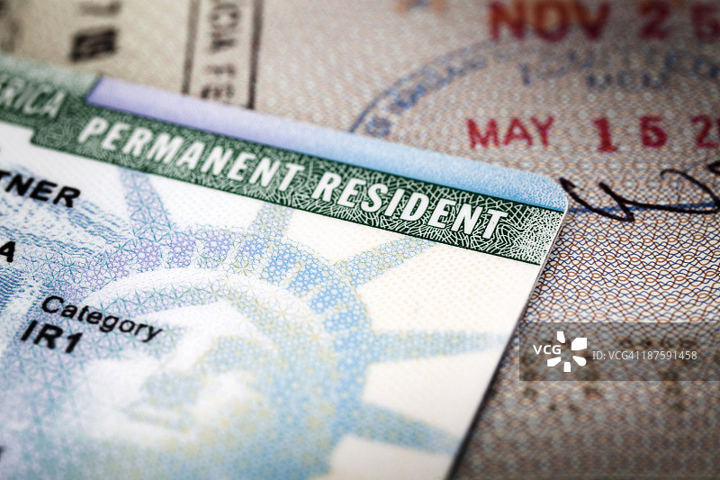 一张放在打开的护照上的美国绿卡特写图片素材