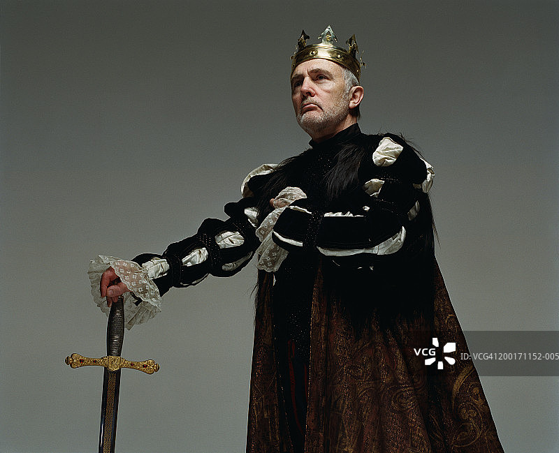 身穿国王服手持剑眺望的老年男人图片素材