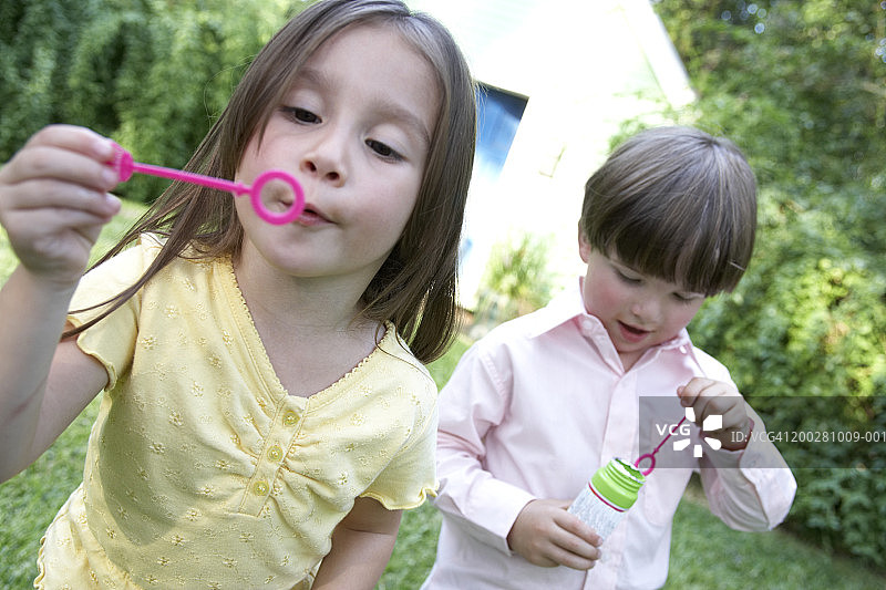 吹肥皂泡的男孩和女孩特写图片素材