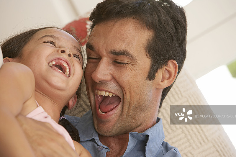 父女（5-7岁）拥抱，欢笑特写图片素材